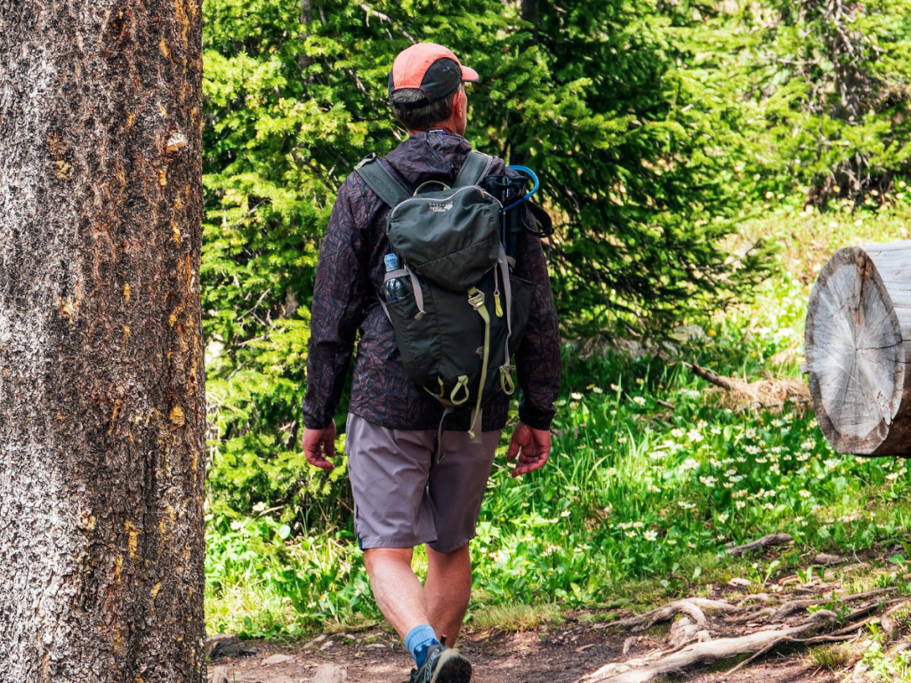 Midlife man in his 40s hiking, thinking about his health and fitness